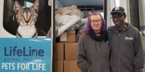 Two LIfeLine employees standing in front of Pets for Life truck.