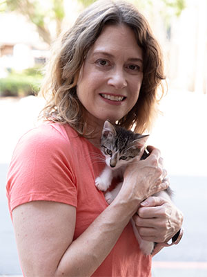 foster parent, Claire holding a small kitten